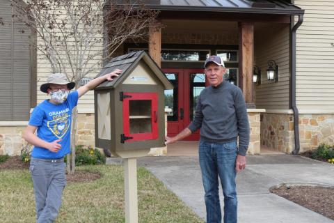 Wilson (left) and Hank (right) posing with the new Little Free Library